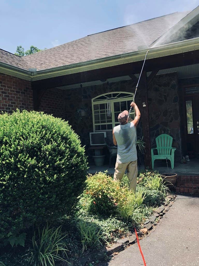 Ken Home Improvement pressure washing a roofline and gutters